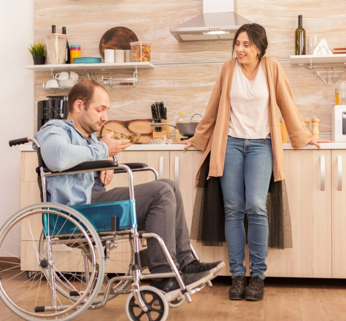 Support worker assisting an NDIS participant with household cleaning and daily home tasks in Melbourne
